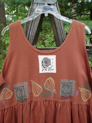 1992 Peplum Top Beach Sienna OSFA: A brown tank top features a logo, downward yoke waist seam, rounded neckline, higher arm openings, wide waist, and gathered bottom flounce, embodying vintage beachy style.