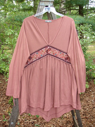 Barclay Decora Banded V Neck Dress Rouge Size 1 displayed on a wooden hanger, highlighting its deep V-neck, vertical pleats, and unique upward bent banded accent.