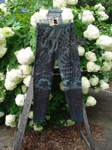 Daisy Hagey Barclay NWT Cotton Lycra Heavy Weight Legging Night Spin Boreal Size 1 in dark teal and black cotton Lycra, hanging on a wooden rack with white hydrangeas behind it.