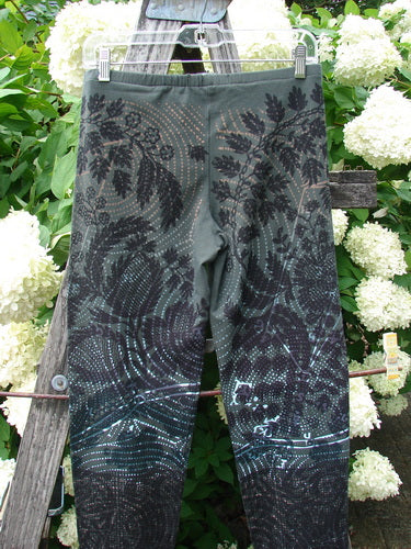 Daisy Hagey Barclay NWT Cotton Lycra Heavy Weight Legging Night Spin Boreal Size 1 in dark green and black cotton lycra, shown hanging on a wooden ladder with white flowers behind it.