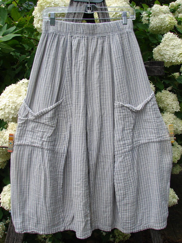 Bluefishfinder.com Barclay Gauze Crop Mojo Pant in unpainted sandy stripe, size 0, shown in a soft gray-and-beige gauze fabric with a wide elastic waistband and cropped, voluminous legs. Large rounded cargo-style pockets and gathered seams add texture and structure against a leafy floral backdrop.