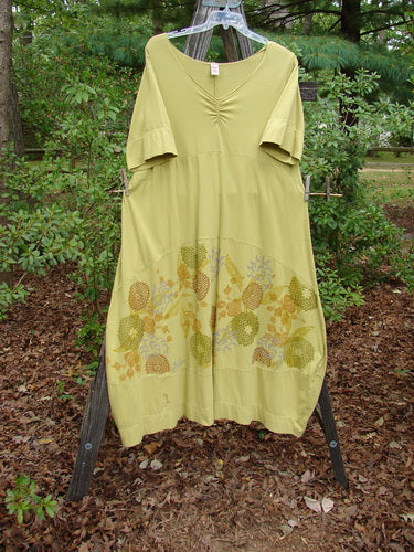 Barclay Gather Sectional Banded Petal Dress Whimsical Garden Split Pea Size 1 displayed on a rack, featuring a floral design, V-shaped neckline, varying hemline, and bell accents.