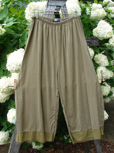 Bluefishfinder.com Barclay Lyocell Flutter Bottom Wide Leg Pant in unpainted yellow olive, size 0, with a soft drape and gathered elastic waist. The wide legs fall into a relaxed silhouette, finished with fluttery lower hems and a muted matte texture.