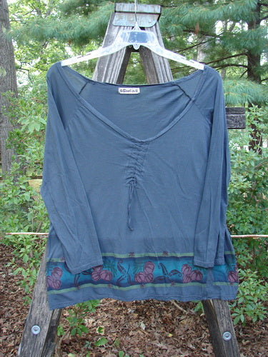 Barclay Batiste Decora Gather Top Gourd Farm Navy Size 1 displayed on a wooden pole, showcasing its deep V-neckline, adjustable drawcord accent, and detailed gourd farm theme paint.