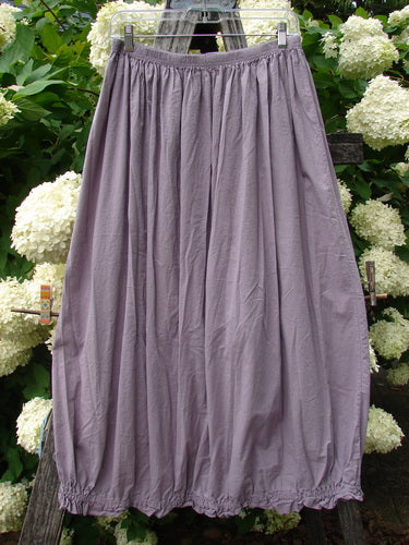 Bluefishfinder.com Barclay Batiste Airy Lawn Skirt in unpainted lavender, size 0, with a gathered elastic waistband and softly wrinkled, lightweight lawn fabric. The full skirt hangs from a clear hanger against white hydrangea blooms and dark greenery.