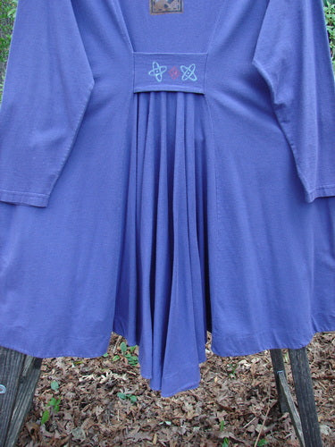 1996 Dining Car Jacket Travel Niagara Size 1 displayed on a pole, showcasing its unique swing hemline, deep V neckline, and artisan porcelain buttons, emphasizing its vintage style and craftsmanship.