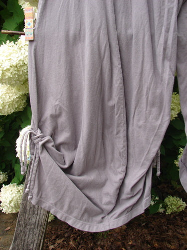 Bluefishfinder.com Barclay Crop Tie Bottom Crop 4 Square Pant, size 0, in unpainted plum cloud. The loose, draped pant panel falls in soft gray-lavender fabric, with a tied crop hem gathered at one side and a smooth, lightweight texture.