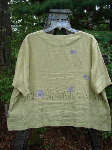 1999 Cabana Top Butterfly Grass Citron Size 2, featuring hand-painted butterflies and snails, shell buttons, a drop pocket, and contrasting fabric lower, reflecting Bluefishfinder.com's vintage and artistic clothing ethos.
