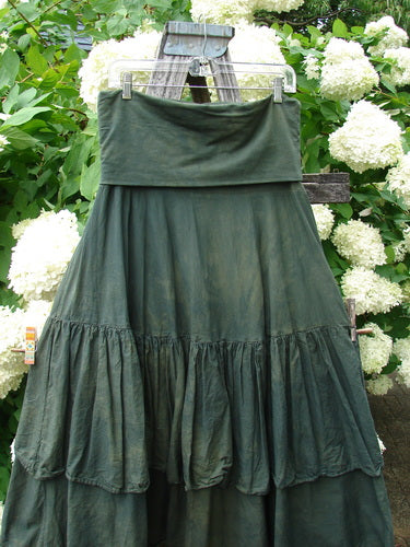 Bluefishfinder.com Barclay Linen Fold Over Two Tier Trinity Skirt, size 0, in mottled army green linen. The skirt hangs from a clear hanger, with a wide fold-over waistband and layered tiered panels that gather into soft, textured ruffles.