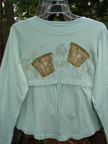 1999 Coffee Top Flowerpot Mint Size 1: Organic cotton shirt with a painted flowerpot theme, super sweeping rounded hemline, ceramic button closures, and drawcord back.