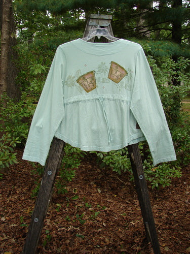 1999 Coffee Top Flowerpot Mint Size 1 displayed on a swing, showcasing its rounded hemline, ceramic button closures, and drawcord back, capturing its unique A-line design and vintage charm.