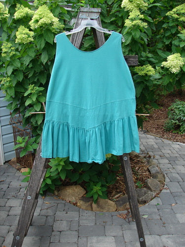 1990 Button Tier Top Unpainted Turq OSFA displayed on a wooden rack, featuring ruffled hemline and gathered flounce, showcasing its vintage, detailed design.