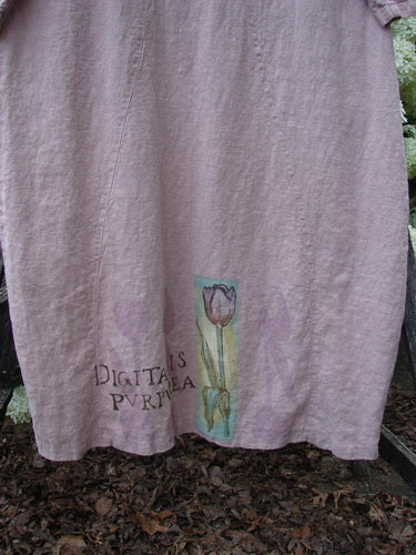 Bluefishfinder.com 1998 Botanicals Thostle Dress Single Tulip Mallow Size 1 in muted lavender fabric, with a loose drape and hand-drawn botanical print near the hem. The lower front shows the words "Digitalis purpurea" beside a slender tulip illustration.