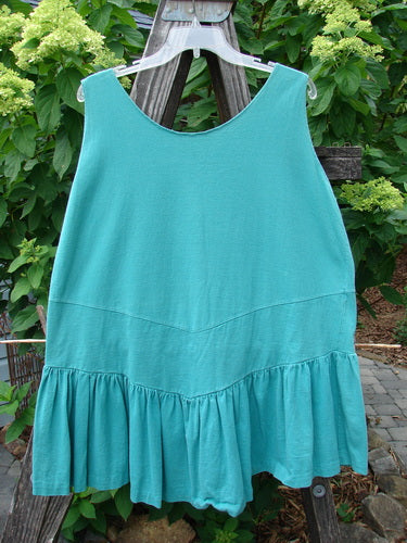 1990 Button Tier Top Unpainted Turq OSFA displayed on a clothes rack, featuring a gathered flounce drop waistband and ruffled hemline, part of a two-piece vintage set from the Summer Collection.