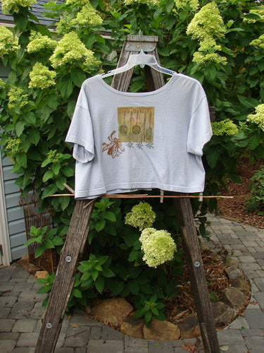 1994 Song Top Vintage Kitchen Garden Lavender Size 1 displayed on a wooden ladder, showcasing its super wide boxy shape, oversized front painted breast pocket, and unique vintage buttons.