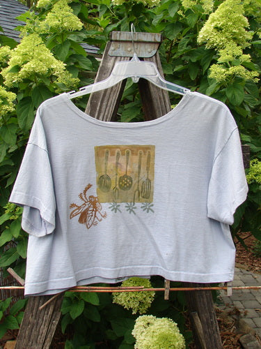1994 Song Top Vintage Kitchen Garden Lavender Size 1, featuring a wide boxy shape, shallow neckline, oversized painted pocket, and vintage buttons, displayed on a hanger.