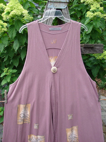 1996 State Fair Vest Pine Twig Laurel Size 1 displayed on an outdoor swing, showcasing its organic cotton fabric, oversized button, varying double-paneled hemline, and super wide A-line shape.