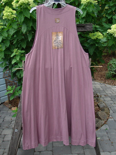 1996 State Fair Vest Pine Twig Laurel Size 1 hanging on a clothesline, showcasing its unique oversized button, double-paneled hemline, and pine twig theme paint, highlighting the vintage Blue Fish Clothing style.