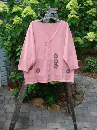 1996 Celtic Jacket of Picts Caille OSFA displayed on a wooden stand, showcasing intricate Celtic-themed patterns, deep V-neckline, multiple front snaps, and contrasting fabric hem pockets.