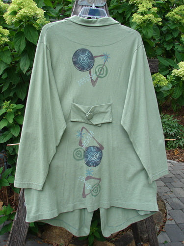 1996 Boulevard Jacket with Giant Pinwheel design in Spanish Moss, Size 0, featuring a cut collar, button accents, and varying hemline. Detailed with two side pockets and four front cloth-covered buttons.