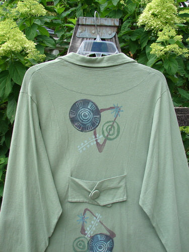 1996 Boulevard Jacket Giant Pinwheel Spanish Moss Size 0, featuring a button-accented collar, button-tabbed back, varying shirttail hemline, two side pockets, and four front cloth-covered buttons.