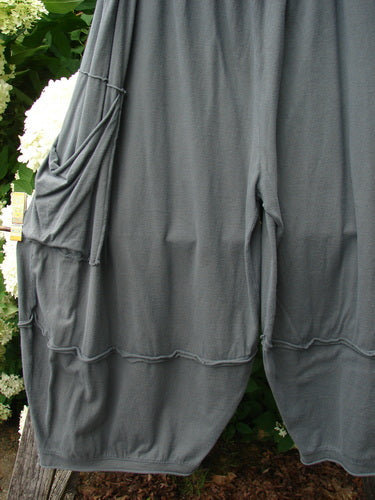 Bluefishfinder.com Barclay Crop 2 Pocket Barrel Pant in Unpainted Steel Night, shown in a soft charcoal gray with a loose barrel shape, cropped hem, and two side pockets. The drapey fabric falls in gentle folds, with seams and gathered edges defining the silhouette.