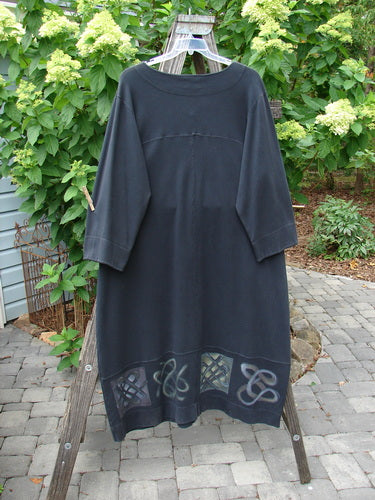 2000 Interlock Glassgow Coat Dress Celtic Black Size 1 displayed on a clothes rack with oversized buttons, a painted bottom panel, and a wide swingy hem.