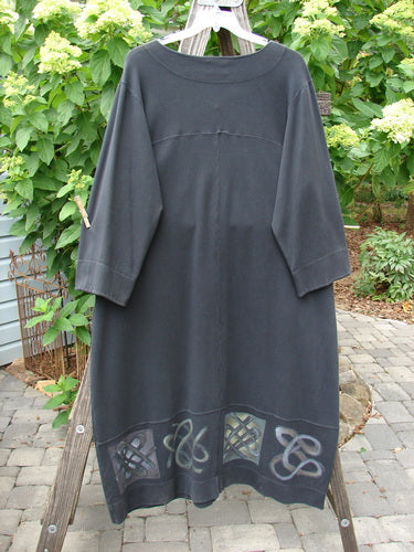 2000 Interlock Glassgow Coat Dress Celtic Black Size 1 hanging outdoors, featuring oversized buttons, wide V-shaped neckline, painted bottom panel, and Celtic-themed design.