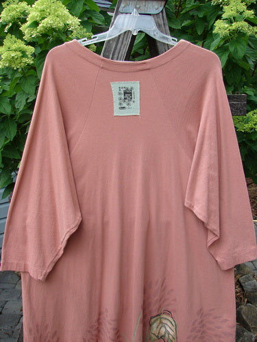 1998 Botanicals Bell Flower Top Magnolia Size 2 displayed on a clothes rack, showcasing its belled A-line shape, scooped front hem, rounded neckline, and sectional panels.