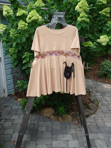 1997 Ocean Pearl Dress Leaf Band Driftwood Size 2 displayed on a rack, showcasing its flowing hem circumference, sweet tiny painted pocket, and slight empire waist seam.