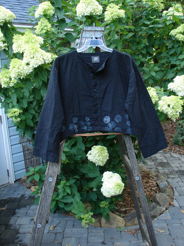 2000 Light Hemp Crop Curve Jacket Moonflower Black Altered Size 1 displayed on a hanger, showcasing front variegated buttons, A-line flair, wide bottom panel, downward back yoke, and moonflower theme paint.