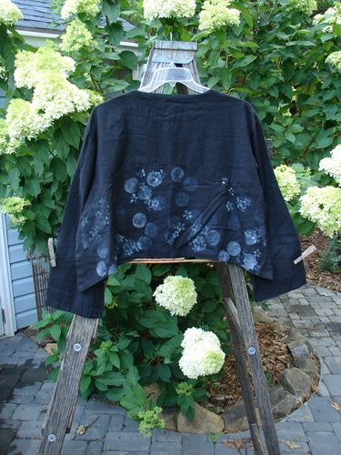 2000 Light Hemp Crop Curve Jacket Moonflower Black Altered Size 1 displayed on a wooden ladder, showcasing front buttons and a flaring bottom panel, perfect condition with unique shoulder seam alteration.