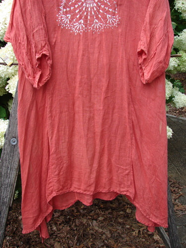 Bluefishfinder.com Barclay Linen High Vent Venetian Dress Center Starburst Poppy Size 1 in faded poppy pink linen, with a white starburst motif at the chest, loose three-quarter sleeves, and a high-vent hem. The airy, textured dress hangs in a soft, draped silhouette.