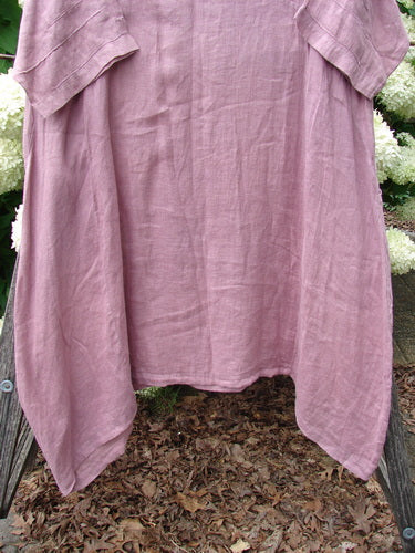 Bluefishfinder.com Barclay Linen Wave Pocket Dress in Dried Sprig Tulsi Rose, size 1, shown as a loose, draped linen dress with a softly wrinkled texture and short sleeves. The muted rose fabric hangs in a relaxed A-line shape, filling the frame with a natural, airy look.