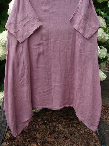 Bluefishfinder.com Barclay Linen Wave Pocket Dress in Dried Sprig Tulsi Rose, size 1, shown in a soft mauve linen with a relaxed drape, wide short sleeves, and large front pockets. The textured fabric hangs in a loose, airy silhouette.