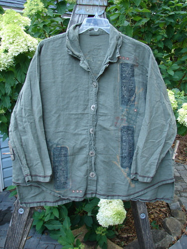 Barclay Hemp Cotton Metal Button Workshirt with Asian Script, displayed on a hanger, featuring exterior contrasting stitchery, full metal button front, shirttail hemline, and stand-up collar. Size 0, Fall Collection.