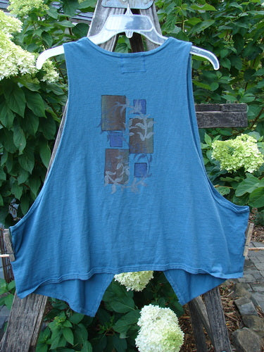 Barclay Calligrapher's Crop Vest Fern Window Blue Tealen Size 1 displayed on a wooden rack, featuring a deep V-neckline, single button closure, and dramatic front points.