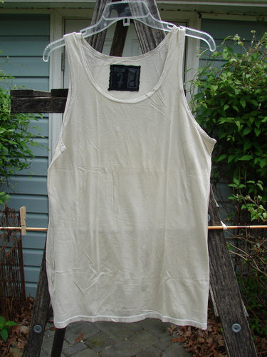 Barclay Lightweight Basic Tank Top Unpainted Pebble Smaller Size 2 on a clothes rack, showcasing its straight bodice and rounded neckline, ideal for layering from BlueFishFinder's vintage collection.