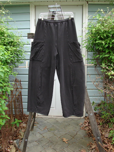 Barclay Interlock Cuff Toboggan Reversible Pant Unpainted Black Size 1 displayed hanging, showcasing its full elastic waist, fleece cuffs, and oversized side pockets, emphasizing comfort and versatility.