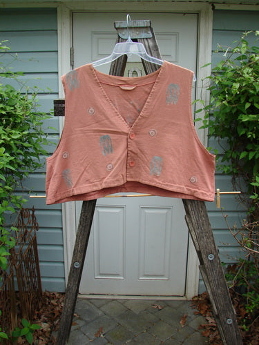 1994 Spruance Vest Topiary Cliff OSFA displayed on a wooden ladder, featuring a unique crop layering length and wide A-line flare, highlighting the vest's intricate topiary-themed design and dual paper button closure.