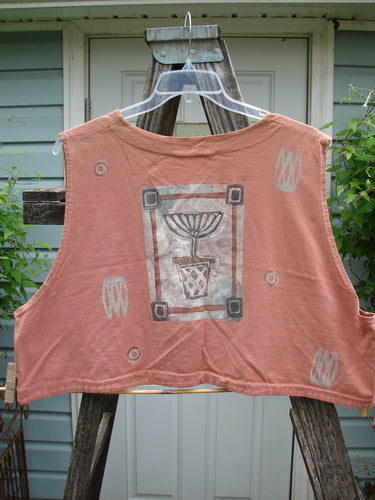 1994 Spruance Vest Topiary Cliff OSFA, featuring a topiary design, is displayed on a hanger. The vest showcases a unique crop layering length and dual paper button closure, embodying vintage Blue Fish style.