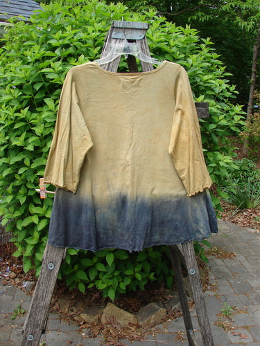 Barclay Three Quarter Sleeved Cafe Tee Sea of Fish Mottled Mustard Size 0 draped over a ladder, showcasing its gradient design and unique features like curly edgings and a rounded neckline.