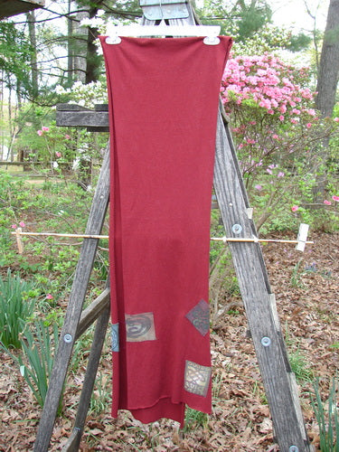 2000 PMU Patched Scarf Celtic Deep Burgundy One Size displayed on a wooden ladder outdoors, highlighting its generous length and unique Celtic-themed patches, part of the PatchMeUp Recycling Program at Bluefishfinder.com.