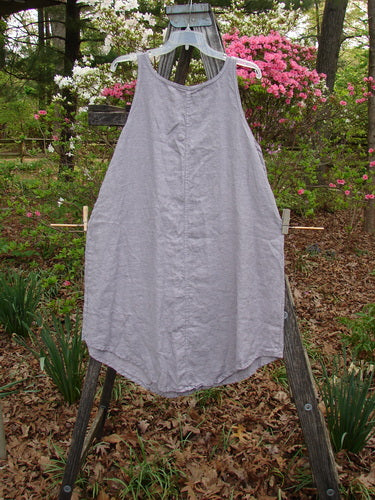 Barclay Linen Round Bottom Pinafore Flying Wing Mallow Size 0 displayed on a clothes rack, highlighting its A-line shape and rounded hem, embodying Bluefishfinder.com's vintage, creative style.