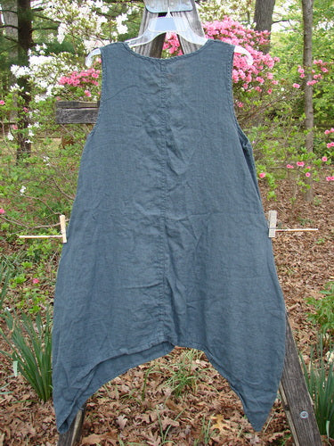 Barclay Linen Side Dip Pinafore with Double Blossom design hanging on a clothesline, showcasing its scoop neckline, A-line shape, and rounded hem, reflecting BlueFishFinder's unique vintage style.