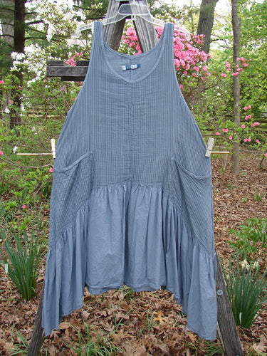 Barclay Gauze Dual Pocket Varano Jumper Unpainted Stripe Moss Size 0, displayed on a clothesline, features a flounce design with deep arm openings and external pockets, embodying vintage Blue Fish Clothing style.