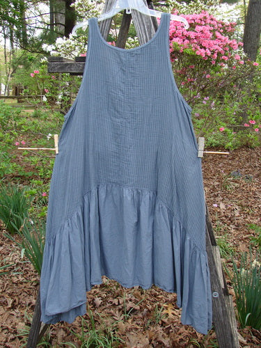 Barclay Gauze Dual Pocket Varano Jumper Unpainted Stripe Moss Size 0 hanging on a clothesline, showcasing its oval neckline, deep arm openings, and distinctive dual pockets against a natural backdrop.