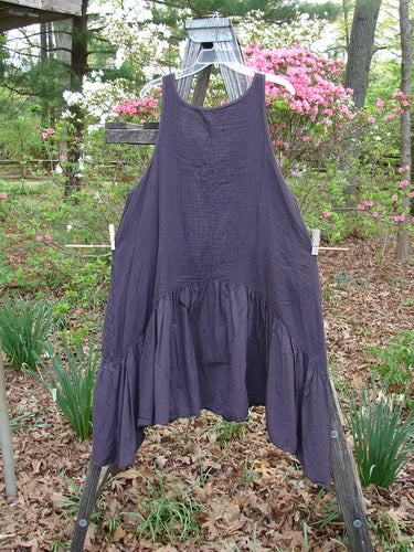 Barclay Gauze Dual Pocket Varano Jumper Unpainted Plum Size 0 displayed on a clothes rack, highlighting its textured upper bodice, flounce skirt, and deep pockets, embodying Bluefishfinder's vintage style.