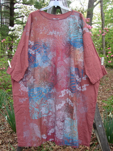 Barclay Linen Oversized Canyon Dress Floral Mountain Brick OSFA hangs on a clothesline, showcasing a rounded neckline, three-quarter dolman sleeves, and generous straight shape, embodying Bluefishfinder's vintage aesthetic.