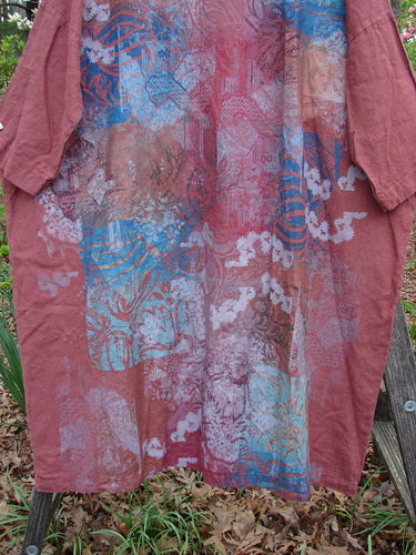 Barclay Linen Oversized Canyon Dress Floral Mountain Brick OSFA, showcasing a rounded neckline and three-quarter dolman sleeves, features a wide, straight shape with a floral mountain design.